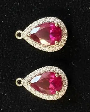 10K Yellow Gold Ruby and Diamond Teardrop Earrings - 1.0 CTW on a starry black velvet background