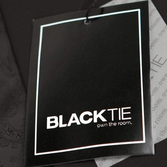 Black tie label with 'BLACKTIE own the room.' text on a textured surface.