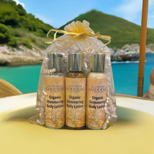 Glimmer Goddess organic shimmering body lotion bottles with a scenic background