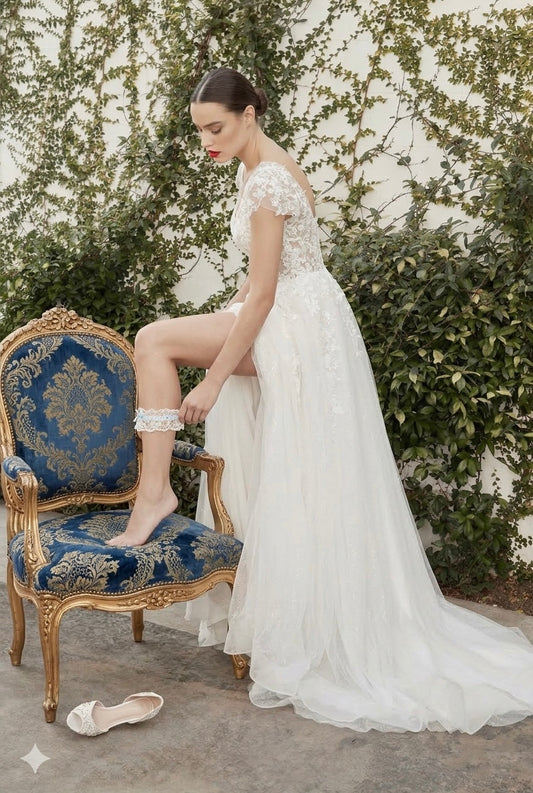 Woman in a white wedding dress sitting on a decorative chair outdoors. video