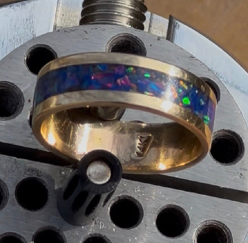 Close-up of hand-channeled electric blue fire opal inlay set in a 5.8g solid 14K yellow gold band.