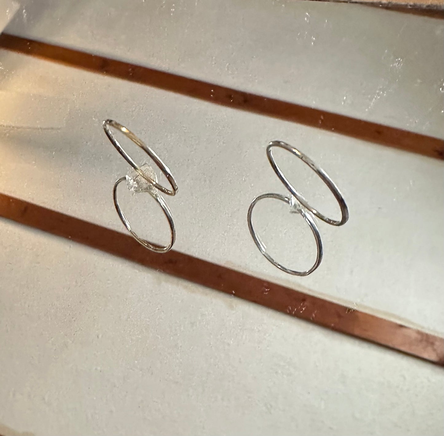 Masterwork Artisan Trio gold and silver ring set. on a mirror 
