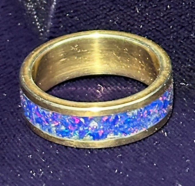 Close-up of hand-channeled electric blue fire opal inlay set in a 5.8g solid 14K yellow gold band.