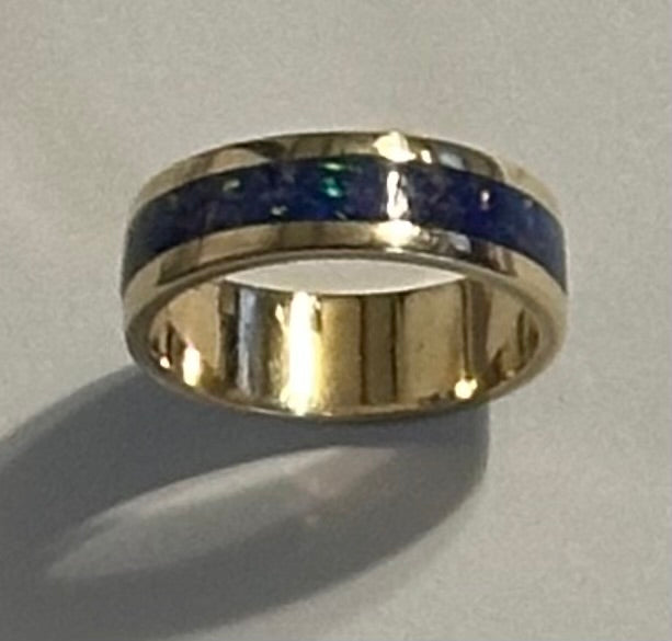 Close-up of hand-channeled electric blue fire opal inlay set in a 5.8g solid 14K yellow gold band.