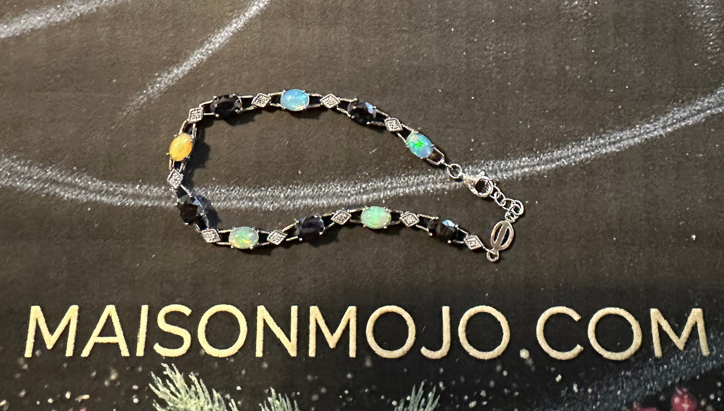 Bracelet on a black card with 'MAISONMOJO.COM' text, decorative elements around