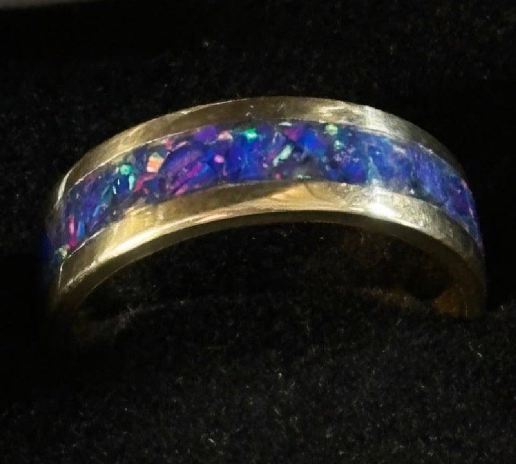 Close-up of hand-channeled electric blue fire opal inlay set in a 5.8g solid 14K yellow gold band.
