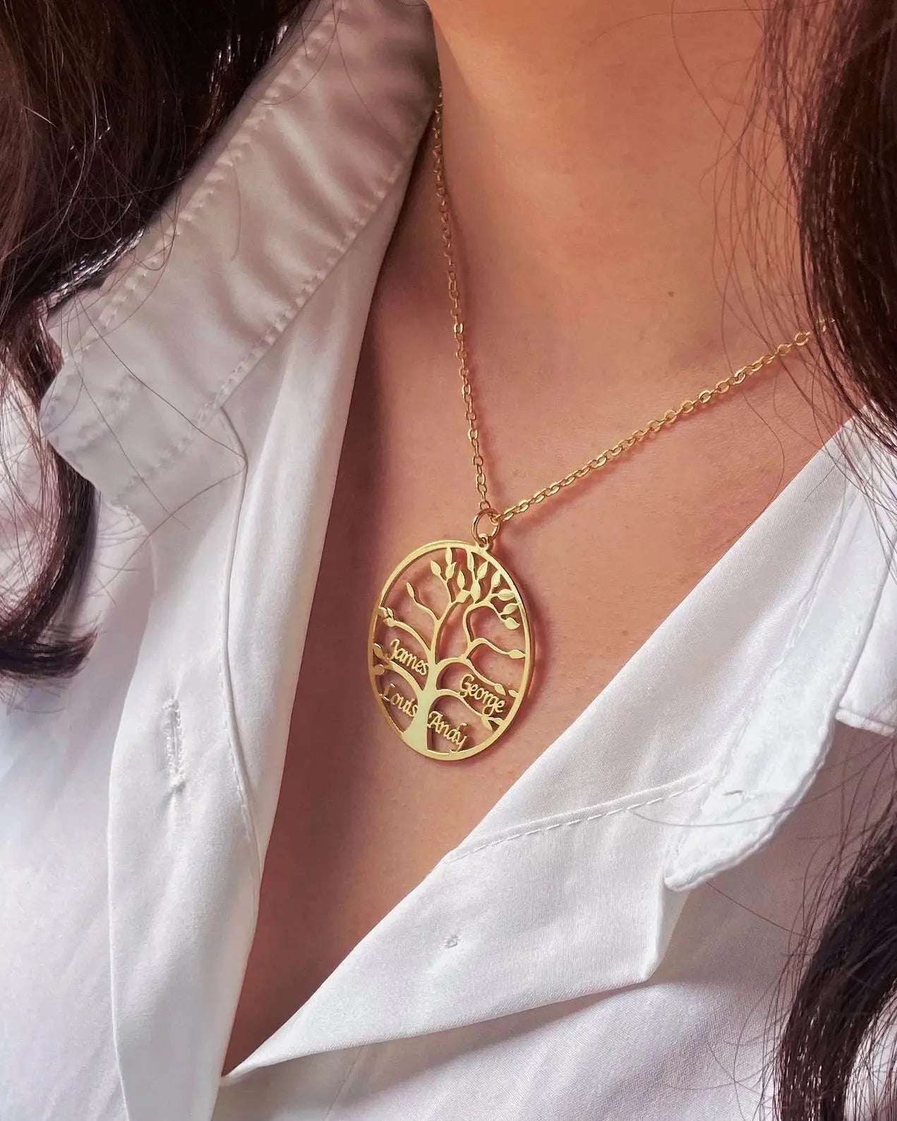 Hand-made gold tree of life necklace featuring personalized name script.