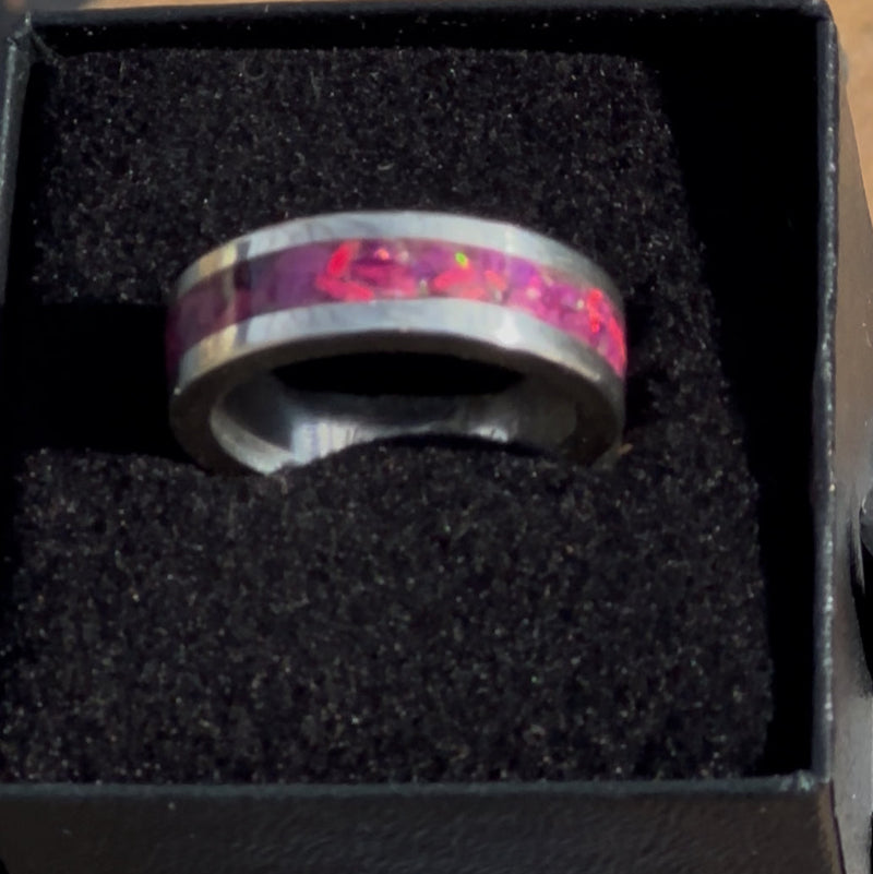 Ring with a pink Opal inlay in a black box