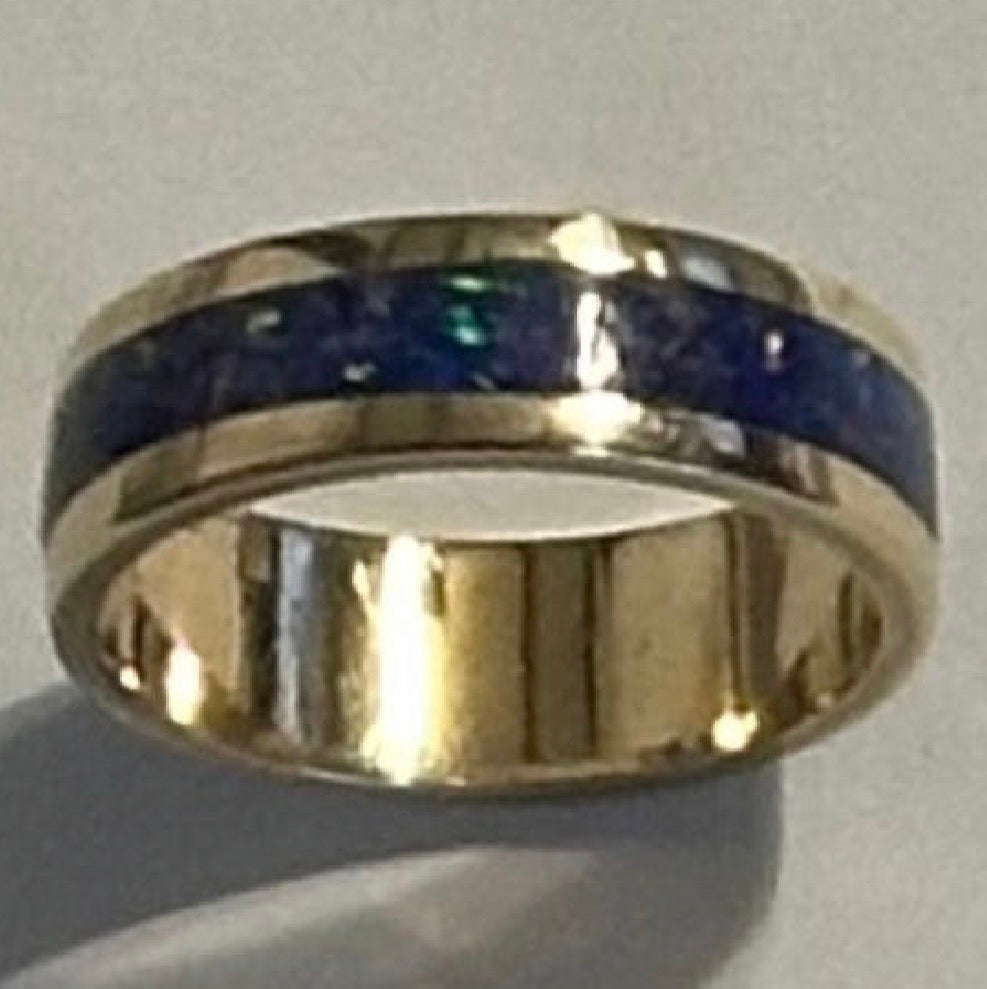 Close-up of hand-channeled electric blue fire opal inlay set in a 5.8g solid 14K yellow gold band.