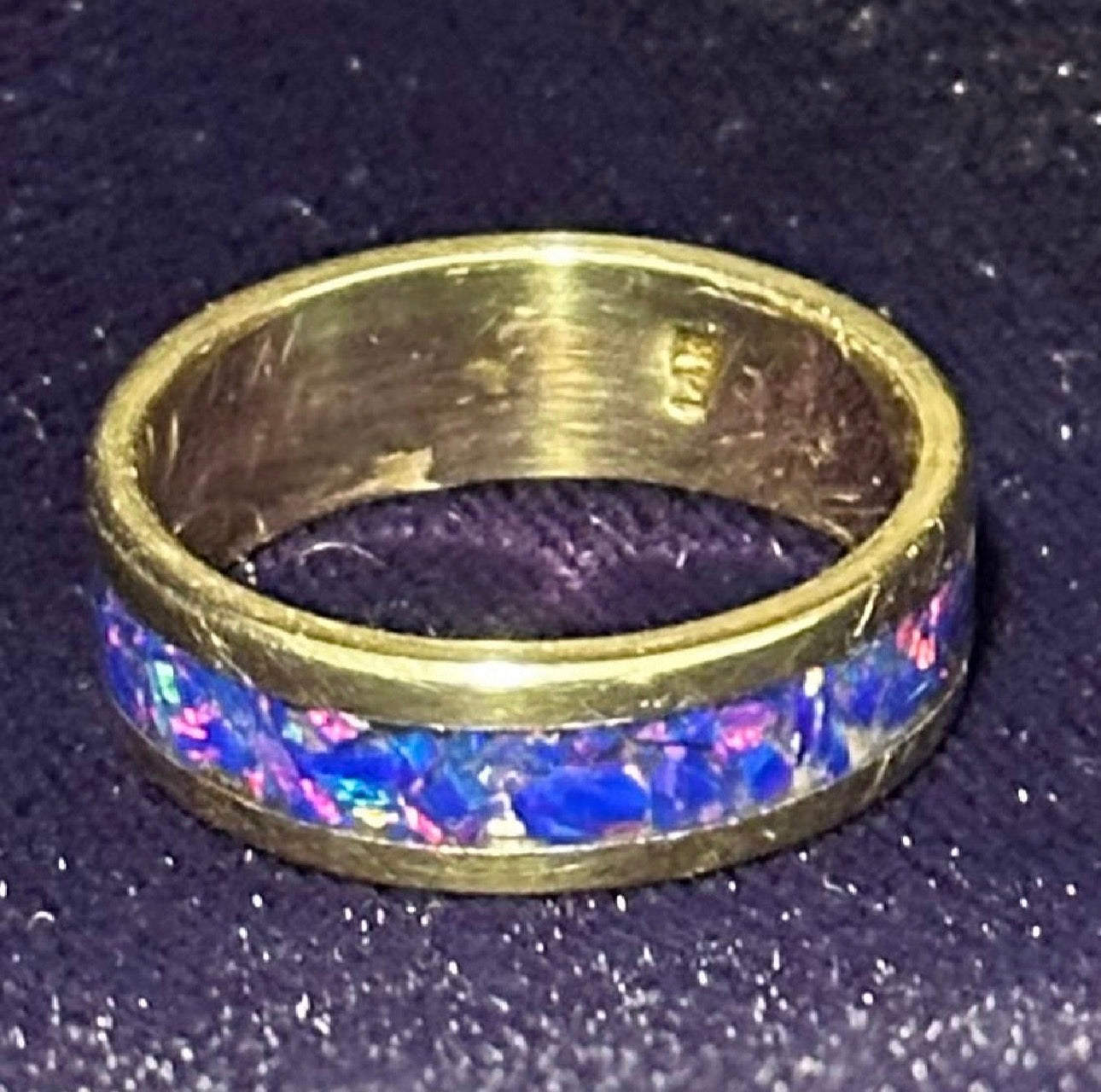 Close-up of hand-channeled electric blue fire opal inlay set in a 5.8g solid 14K yellow gold band.