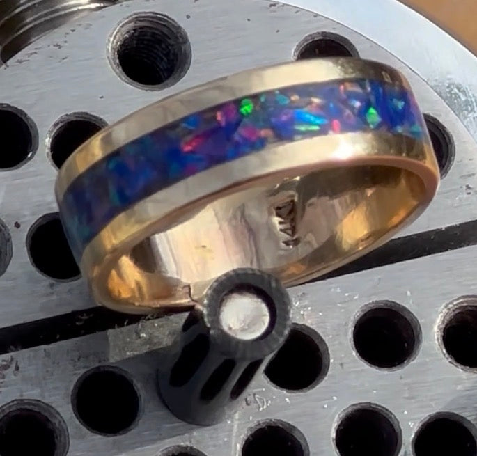 Close-up of hand-channeled electric blue fire opal inlay set in a 5.8g solid 14K yellow gold band.