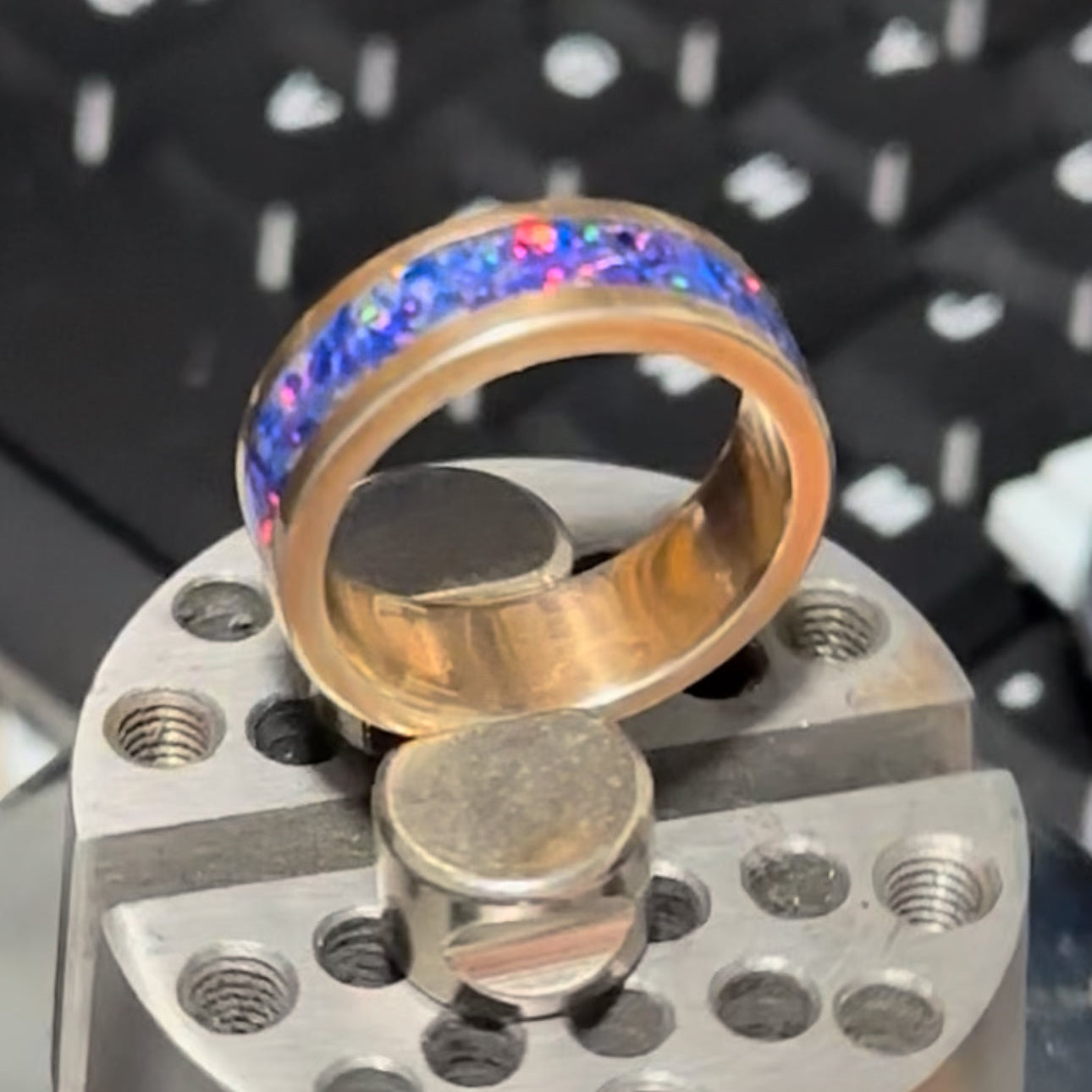 Multicolored ring on a metal stand with a blurred background