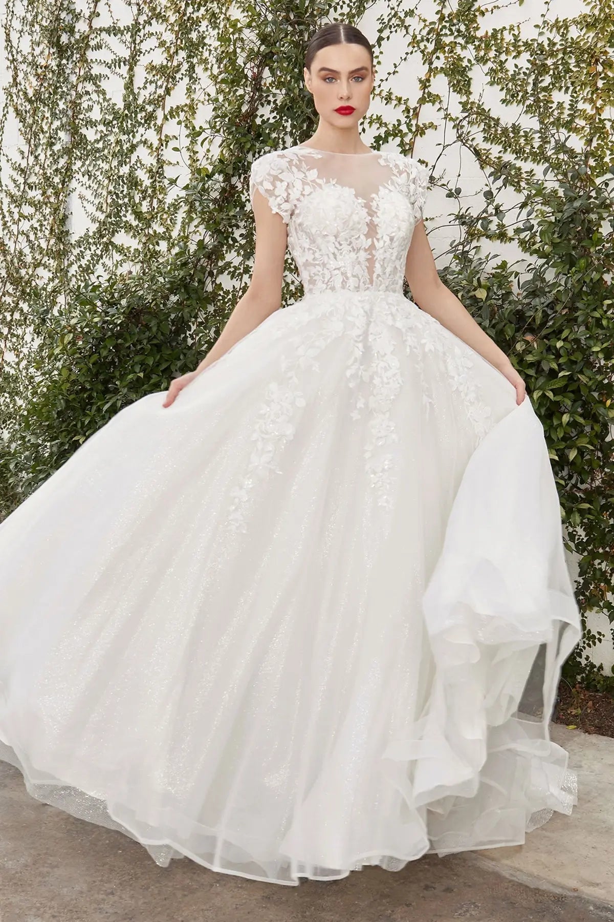 White wedding dress with floral details on a model against a natural background