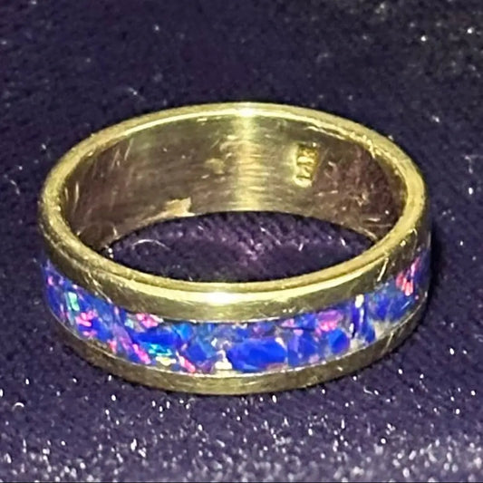 The "Masterwork" 5.8g Solid 14K Gold & Blue Opal Band (Size 11) on a shiny purple velvet background
