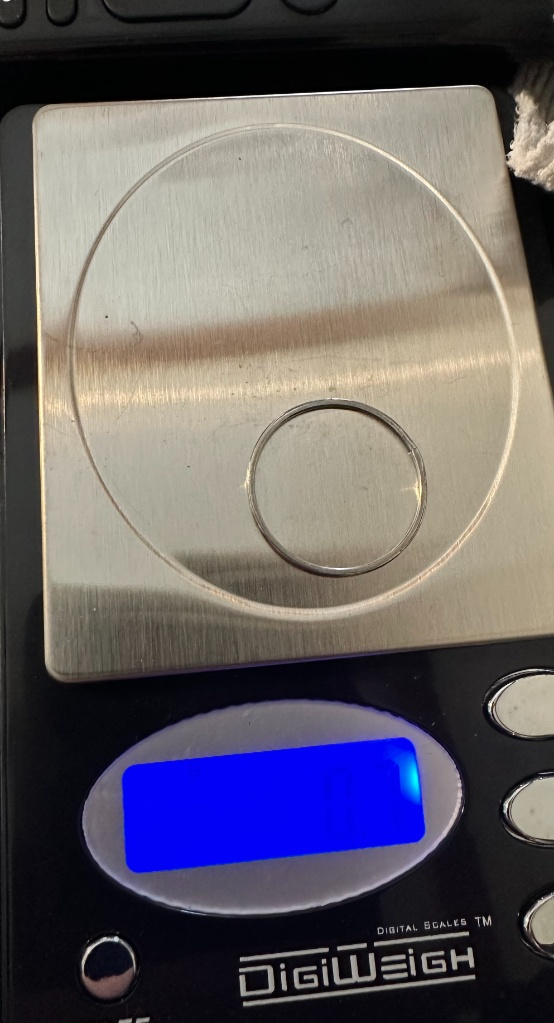 Digital scale with a 925 silver ring and is playing '0.7' on the screen.