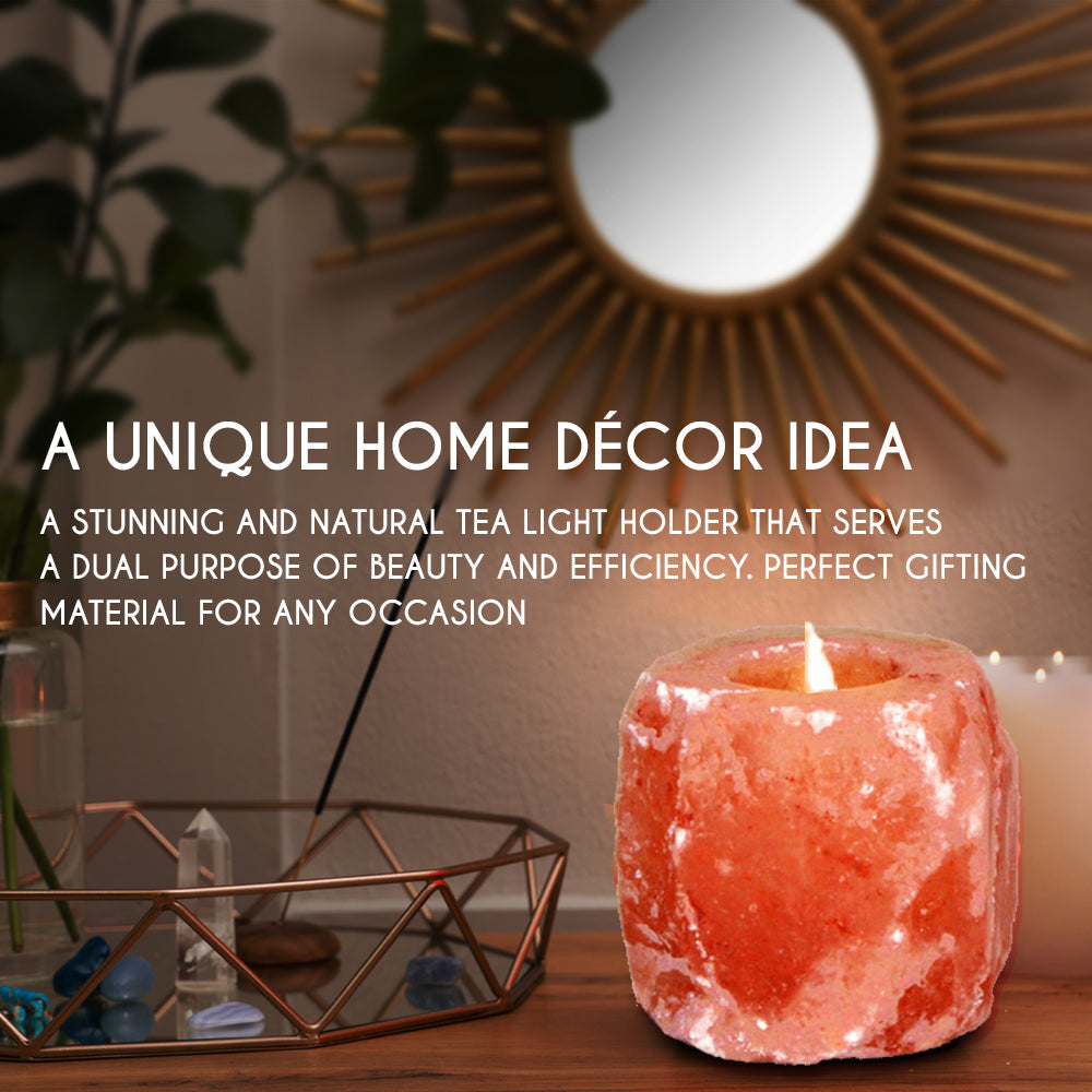 "Natural shape Himalayan pink salt tea light holder on a wooden table with a glowing candle."