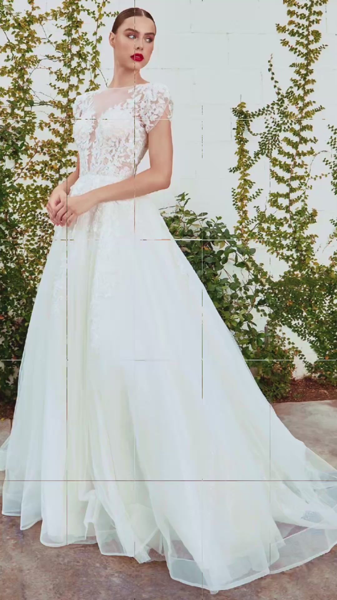 Woman in a white lace wedding dress standing outdoors with greenery in the background video 