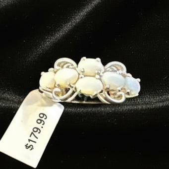 White opal ring on Christmas backdrop with ornaments - $179.99
